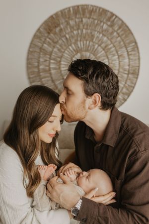 Intimate couple shares tender romantic moments in a series of five candid photographs against neutral backdrop.
