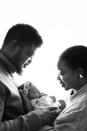 Black and white sequence showing tender moments between parent and baby in silhouette profile views.