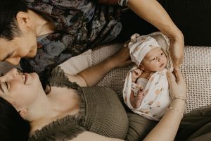 Cozy lifestyle portrait session showing tender family moments in muted tones.