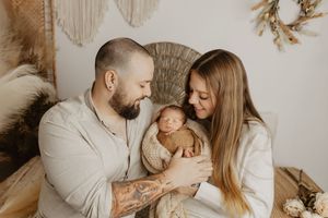 Loving family portrait series in soft neutral colors with minimalist styling.
