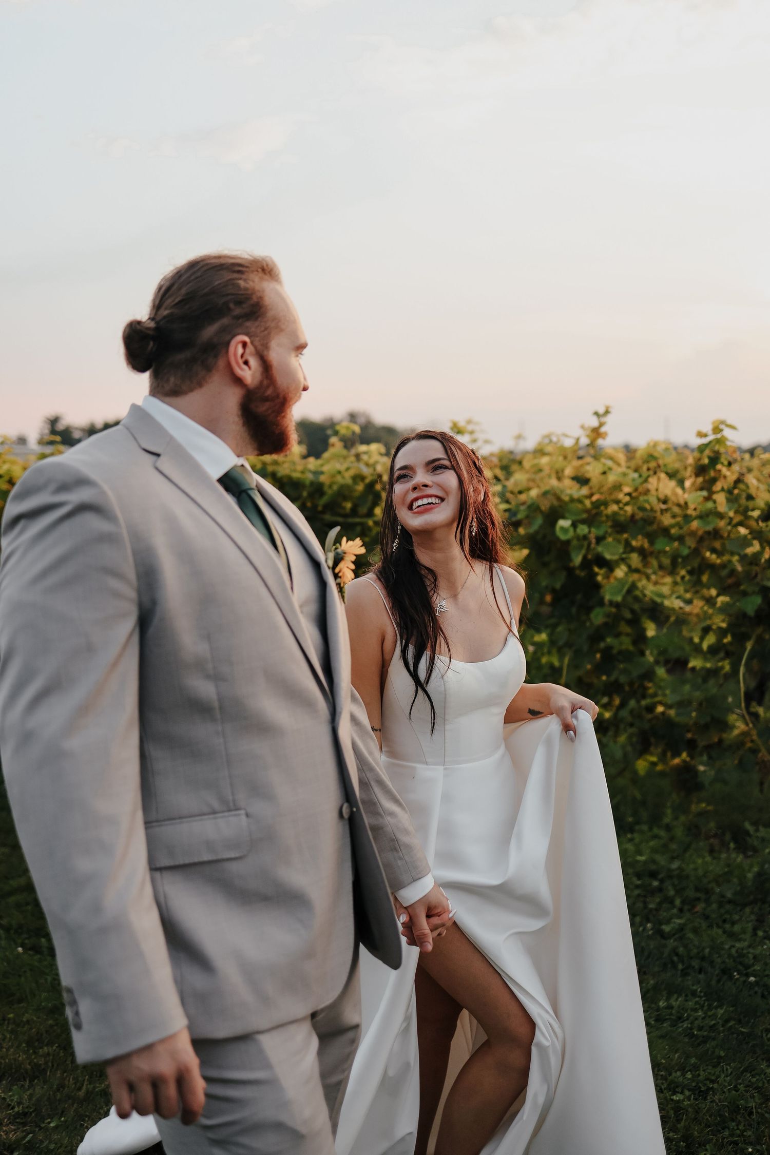A joyful mature couple embracing outdoors in wedding attire.