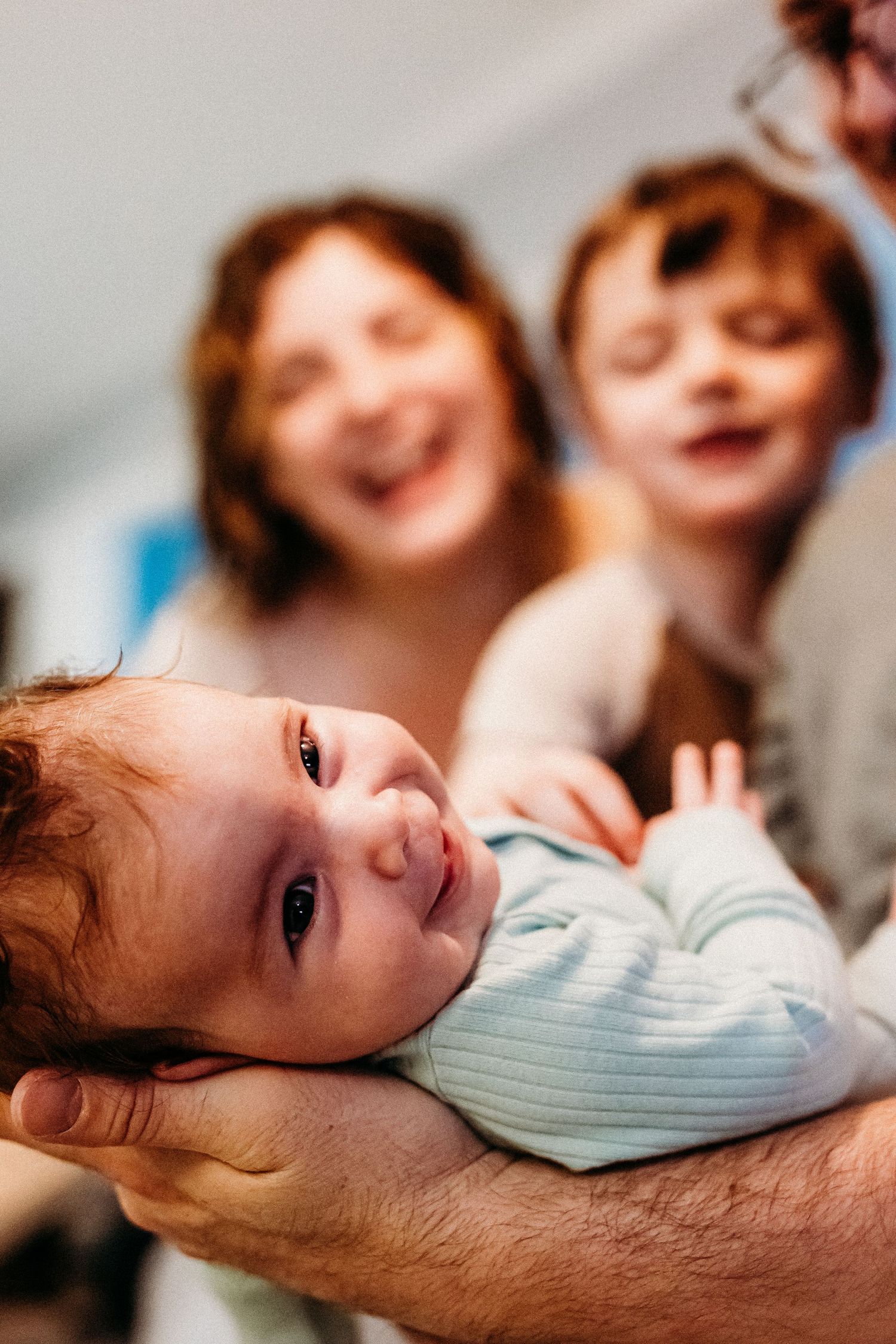 A candid moment of joyful laughter during a fun indoor gathering captures genuine emotion and connection.