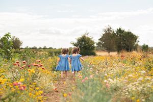 Twin sisters walking in a flower field in Knaresborough