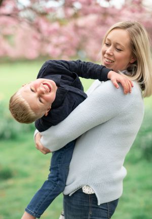 Amother tickles her son under the cherry blossom trees in Harrogate.