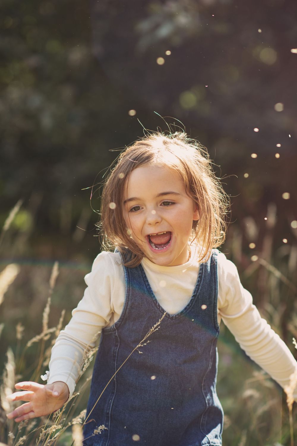 A child playing in long grass at Otley Chevin