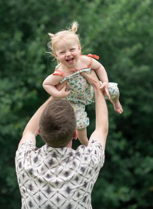 Child playing with her dad outdoors
