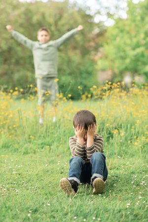 A photo sof two brother playing hide and seek.