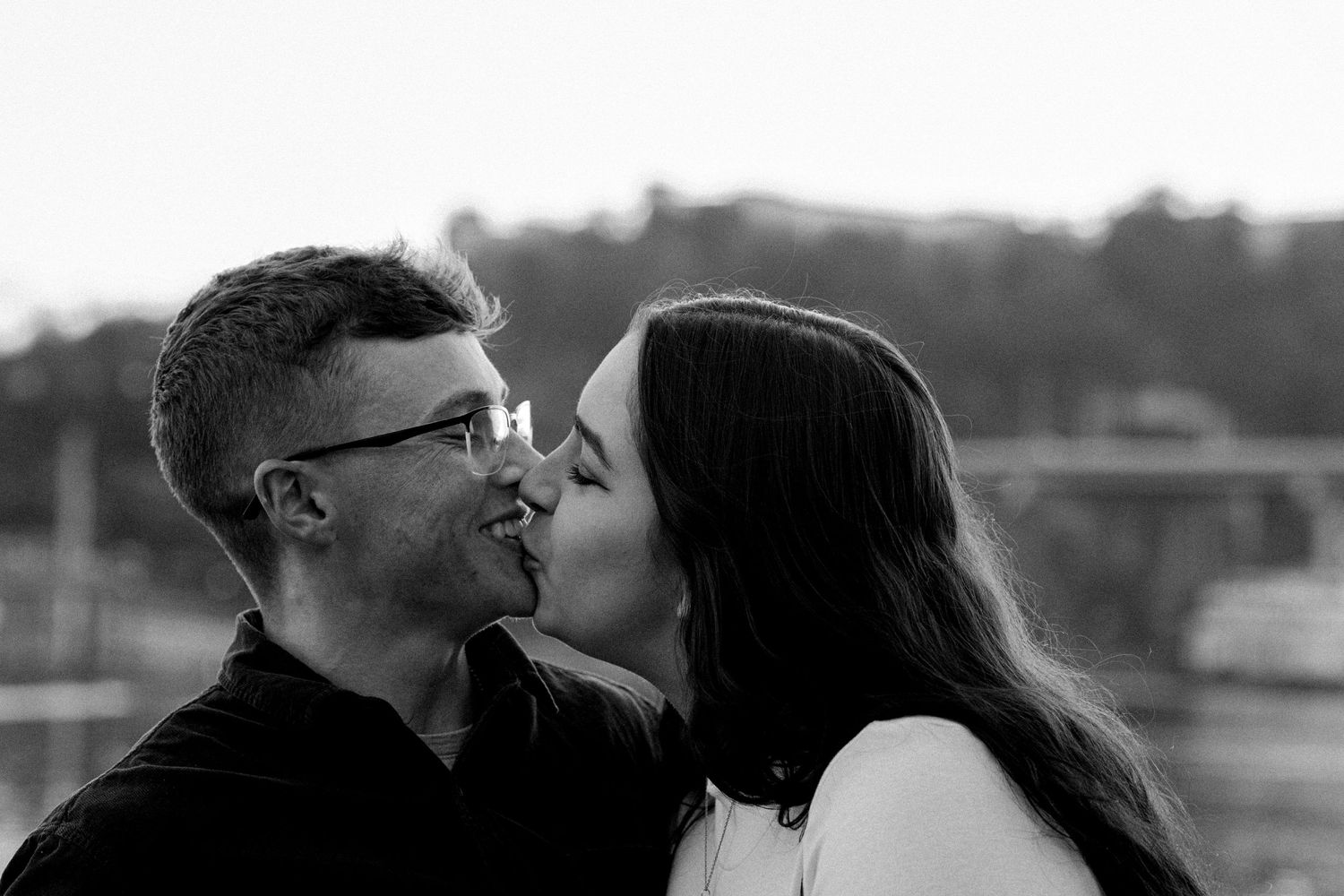 Couple celebrating their engagement in downtown Chattanooga with a kiss