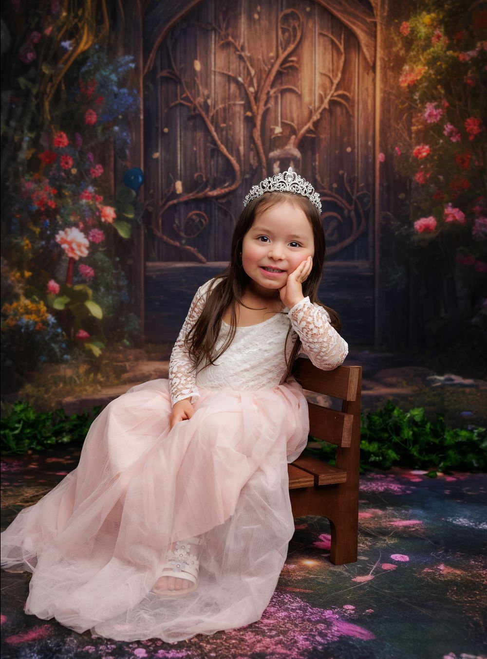 Enchanted garden princess photoshoot with magical doorway and floral backdrop.