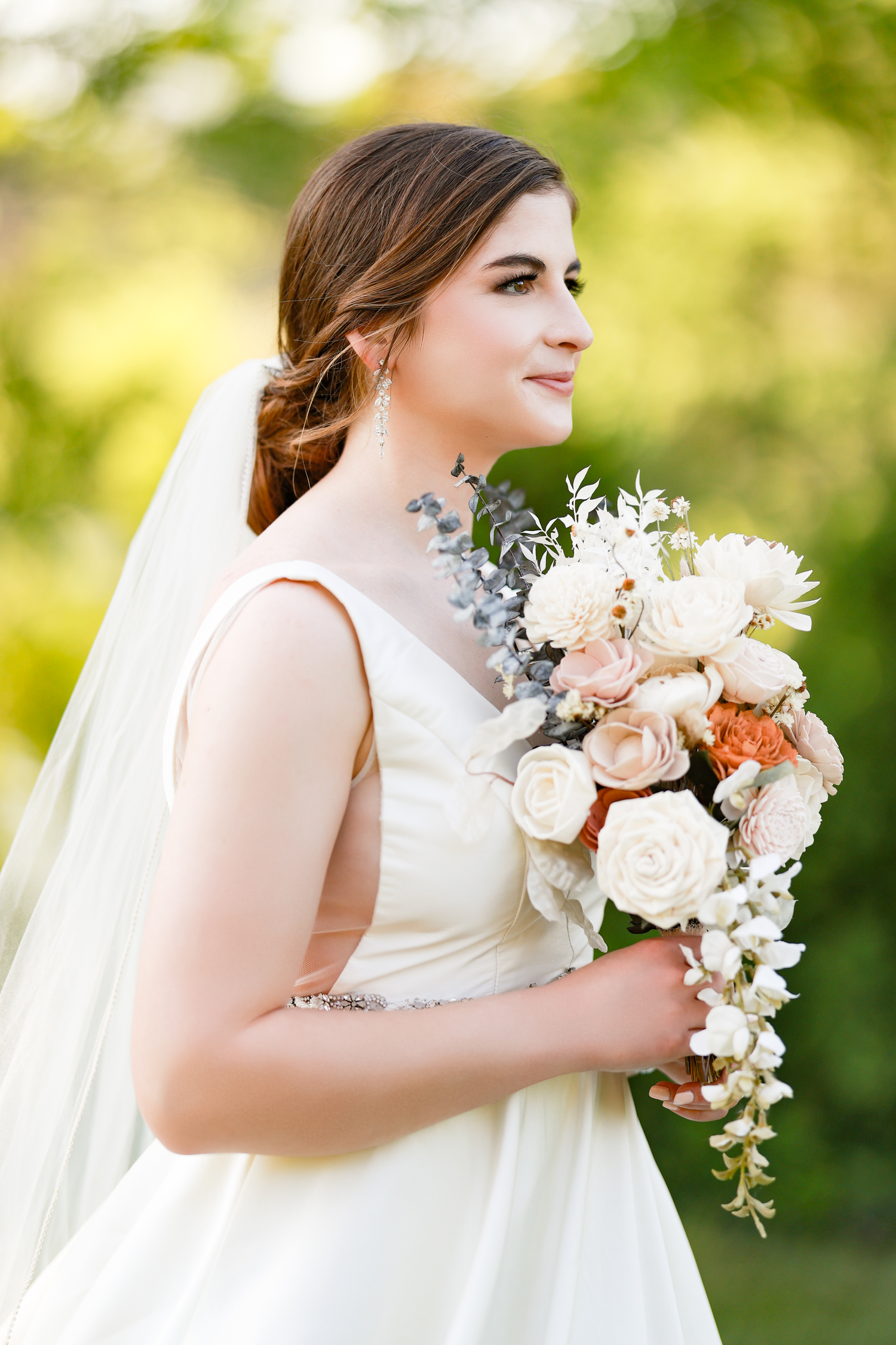 Maryland bride in white wedding dress holding elegant bouquet of roses and greenery.