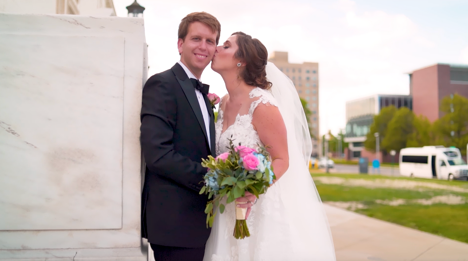 Classic wedding photography session outside modern urban architecture.