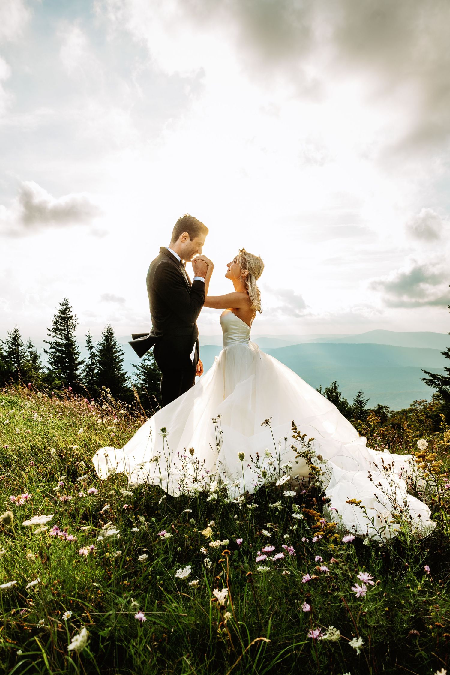 Bride and groom share a snuggle at sunset in the field of Spruce Knob Mountain during their elopement | west virginia elopement photographer