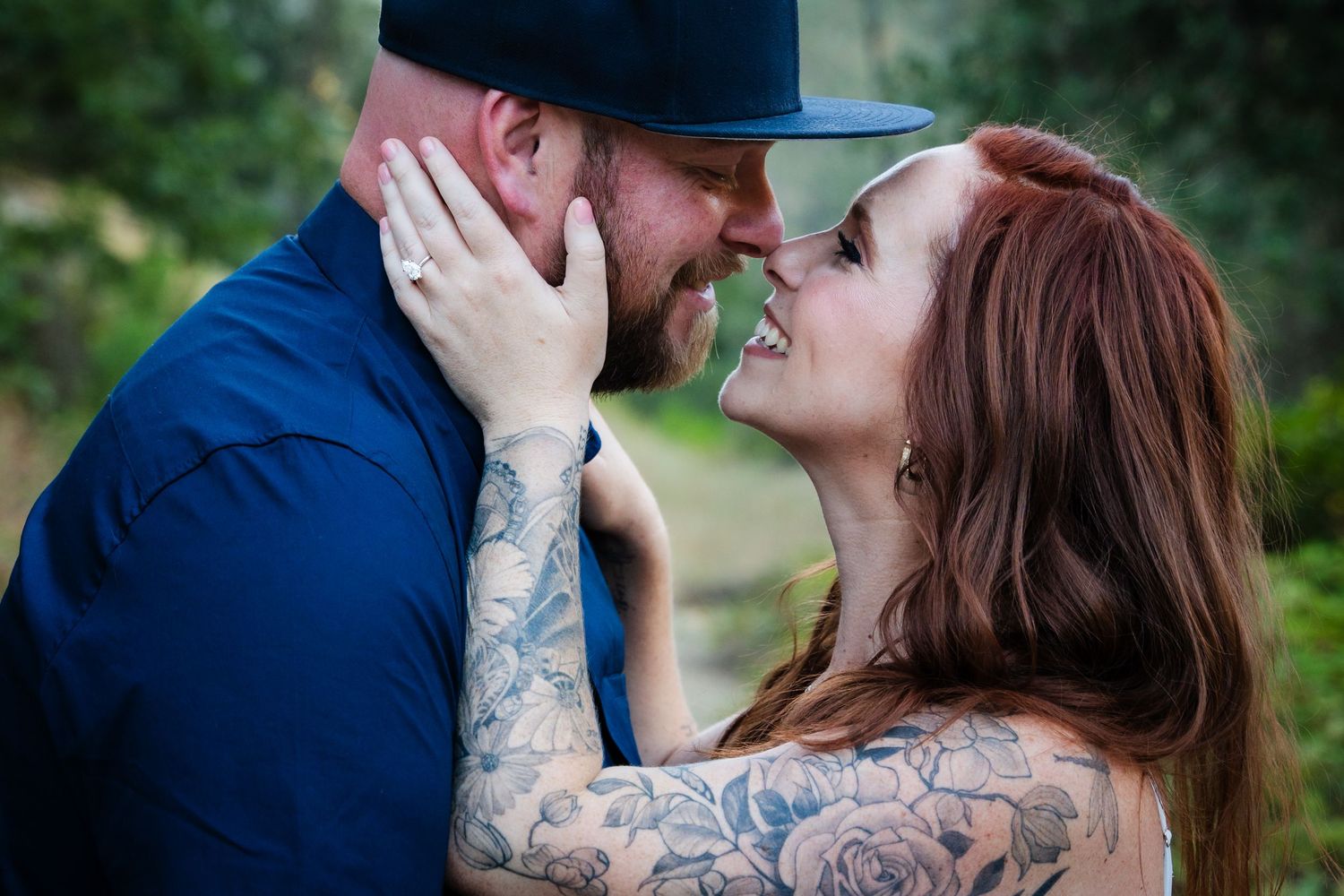 A romantic couple in an outdoor setting sharing multiple tender moments with green foliage in the background.