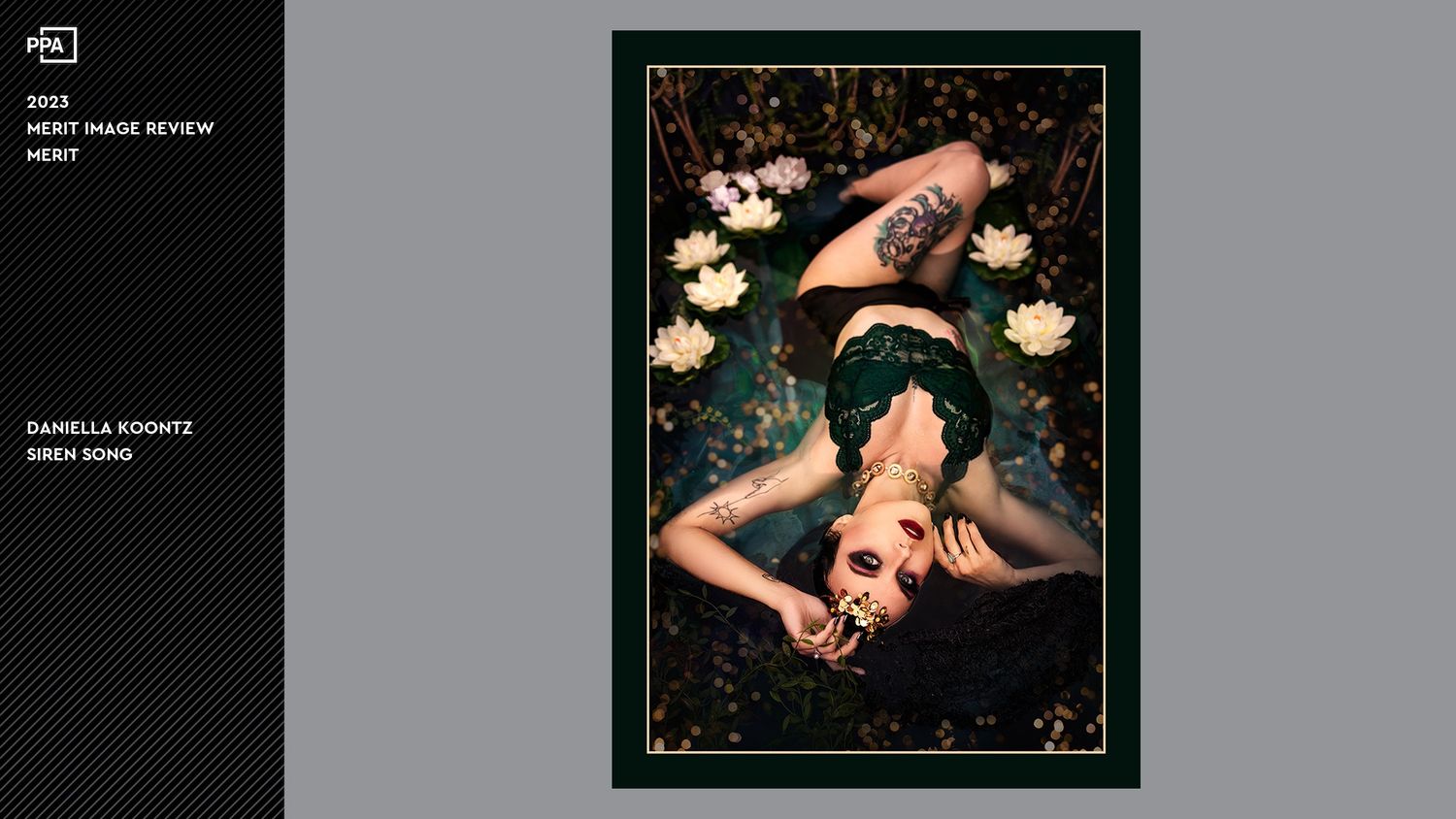 Artistic overhead photo of a person lying among white flowers on dark background.