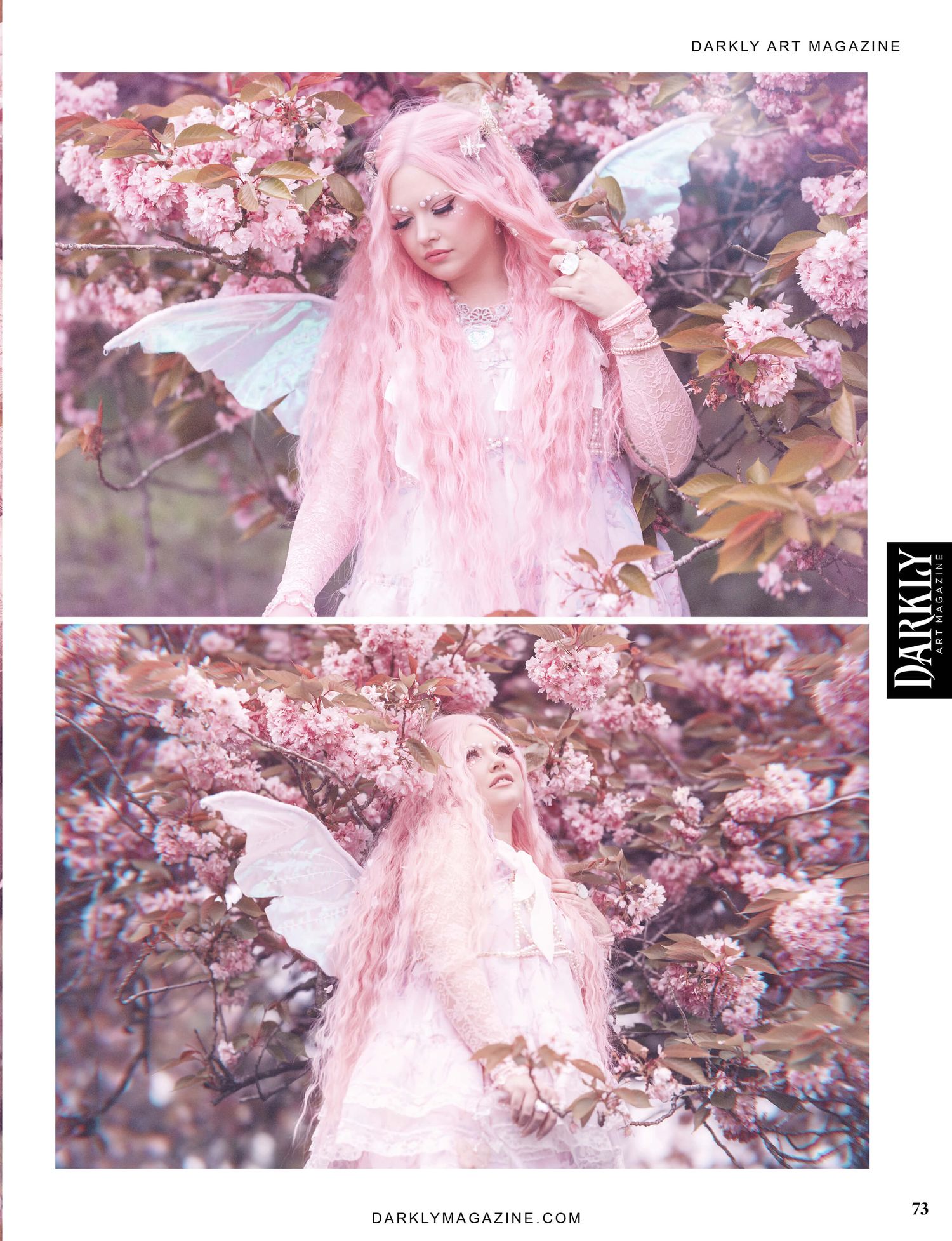 A woman dressed as a fairy with pink hair and wings, standing among pink blossoms. The image is from Darkly Art Magazine
