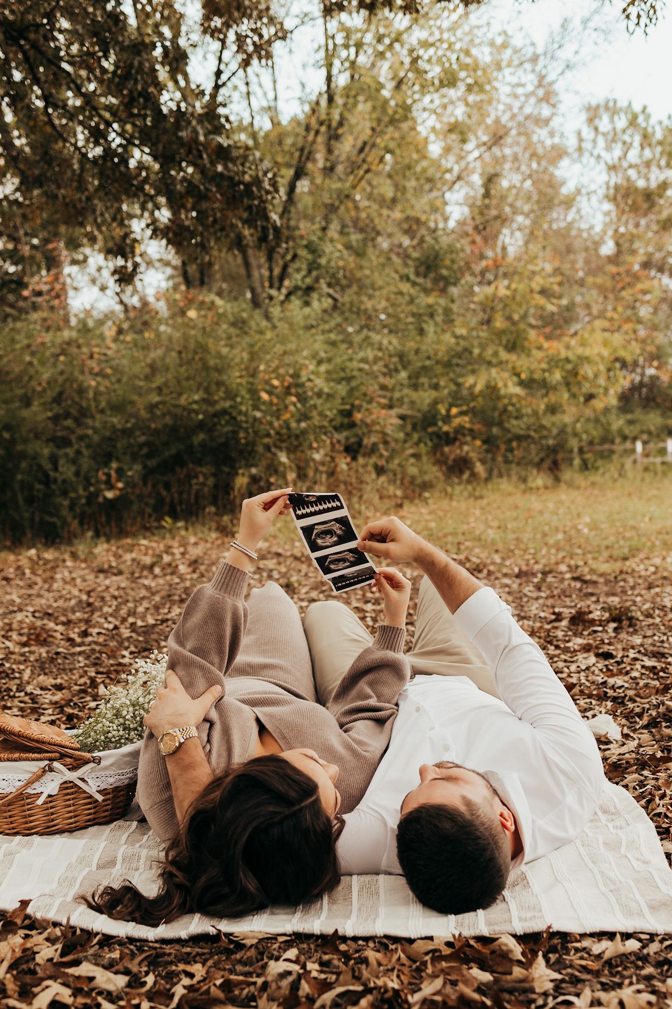 mom and dad to be laying on their backs looking up at their ultrasound photos.