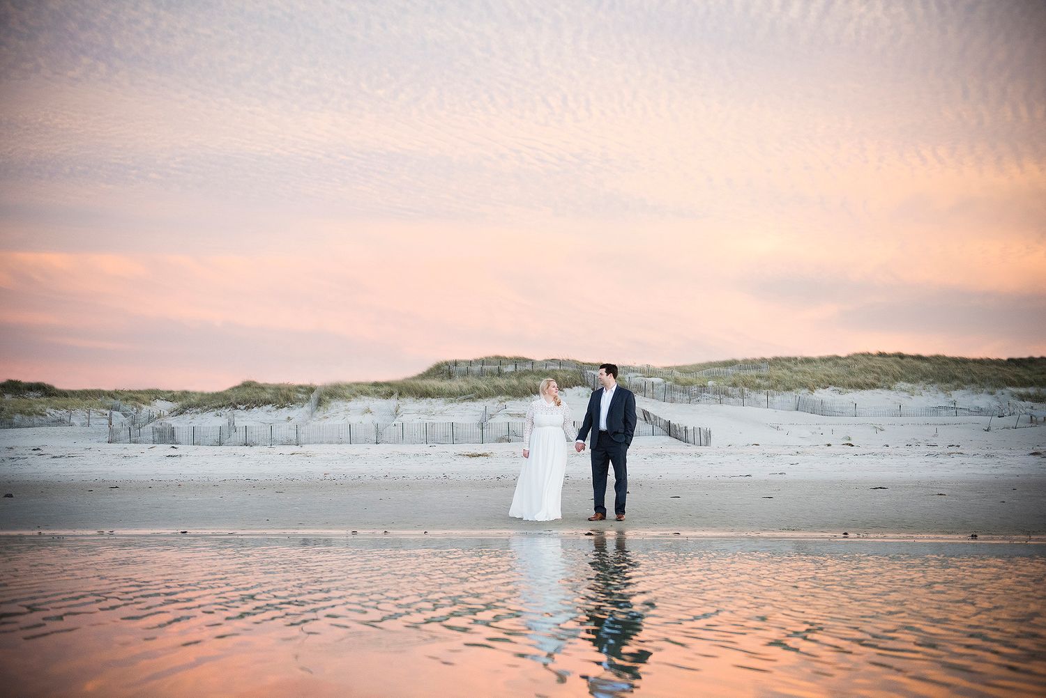Bride and groom on the beach on Cape Cod at sunset.