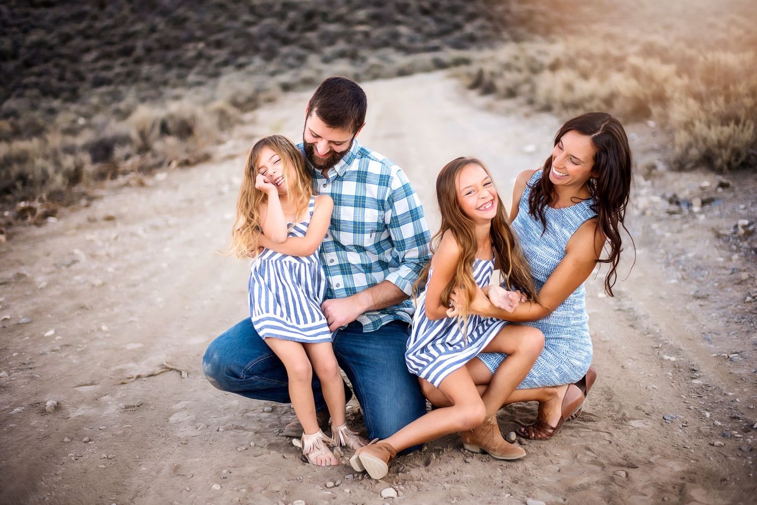 Family laughing as they sit and pose for family photography in Wenatchee, Washington