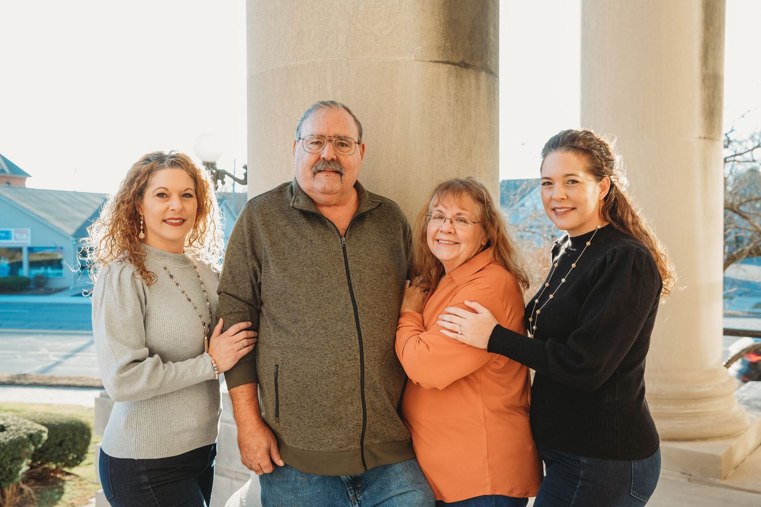 Family portrait of photographer with her sister, dad, and step-mother. Doughman Photography.
