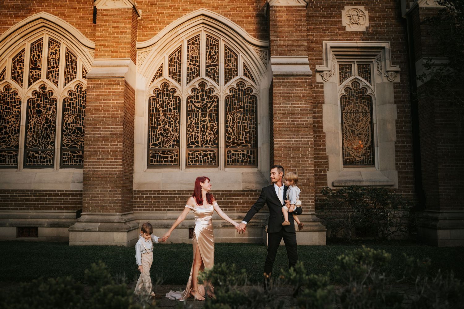 Family walking along a church while Family Photographer Snaps a "Beatles" Shot in Jacksonville Florida