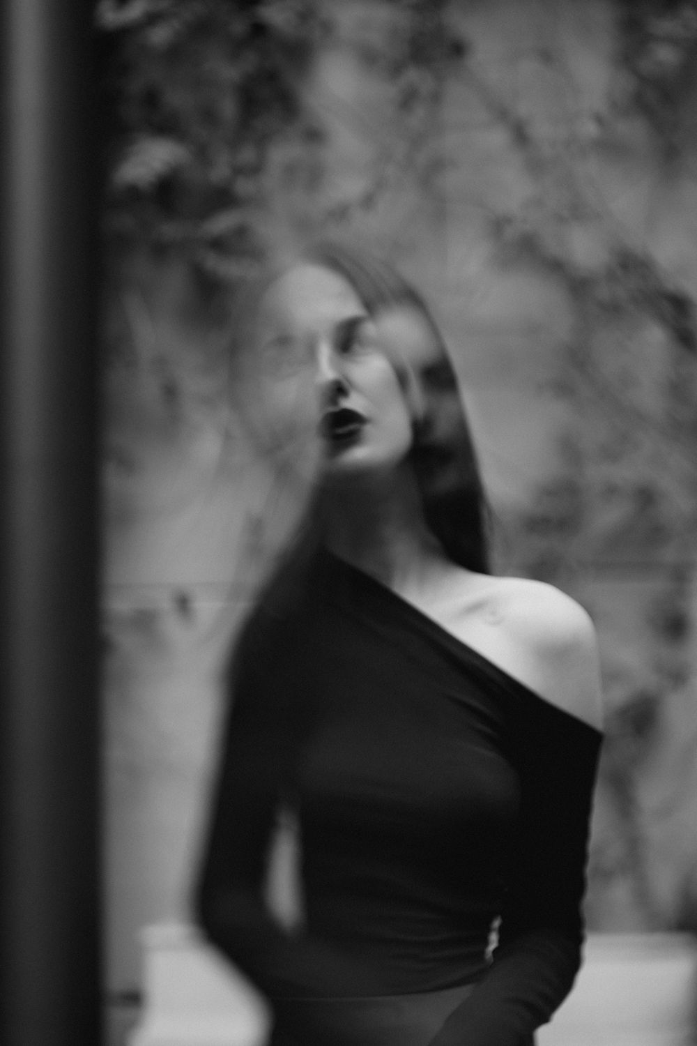 Artistic black and white portrait series with soft focus and dramatic poses.