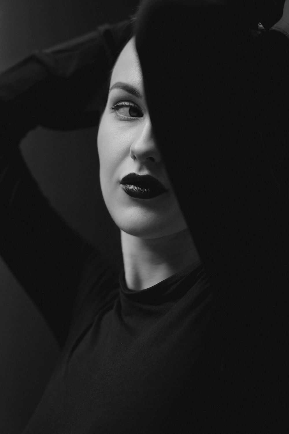 High contrast black and white portrait series emphasizing lips and dramatic shadows.