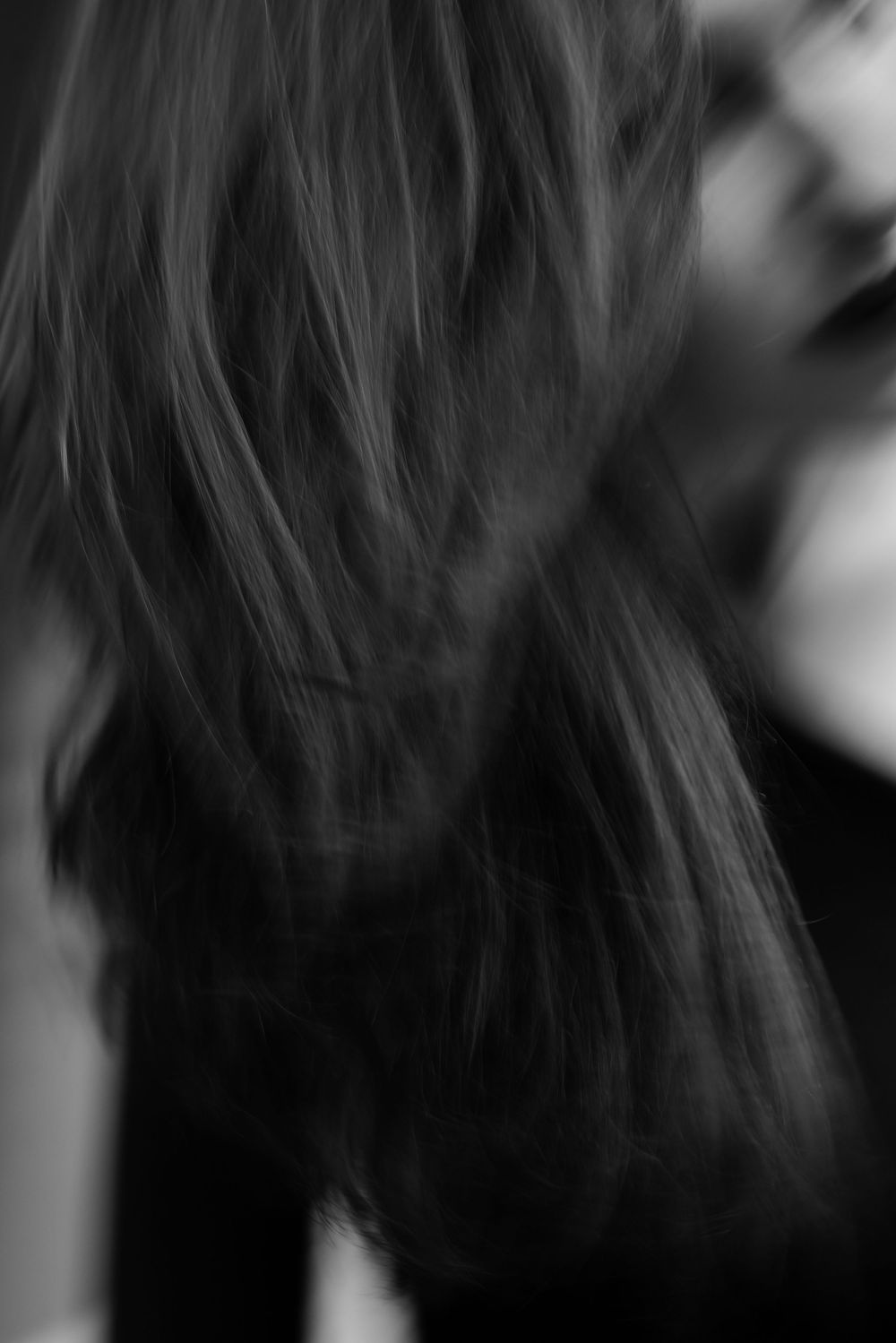 Close-up abstract shots of dark flowing hair with shallow depth of field.