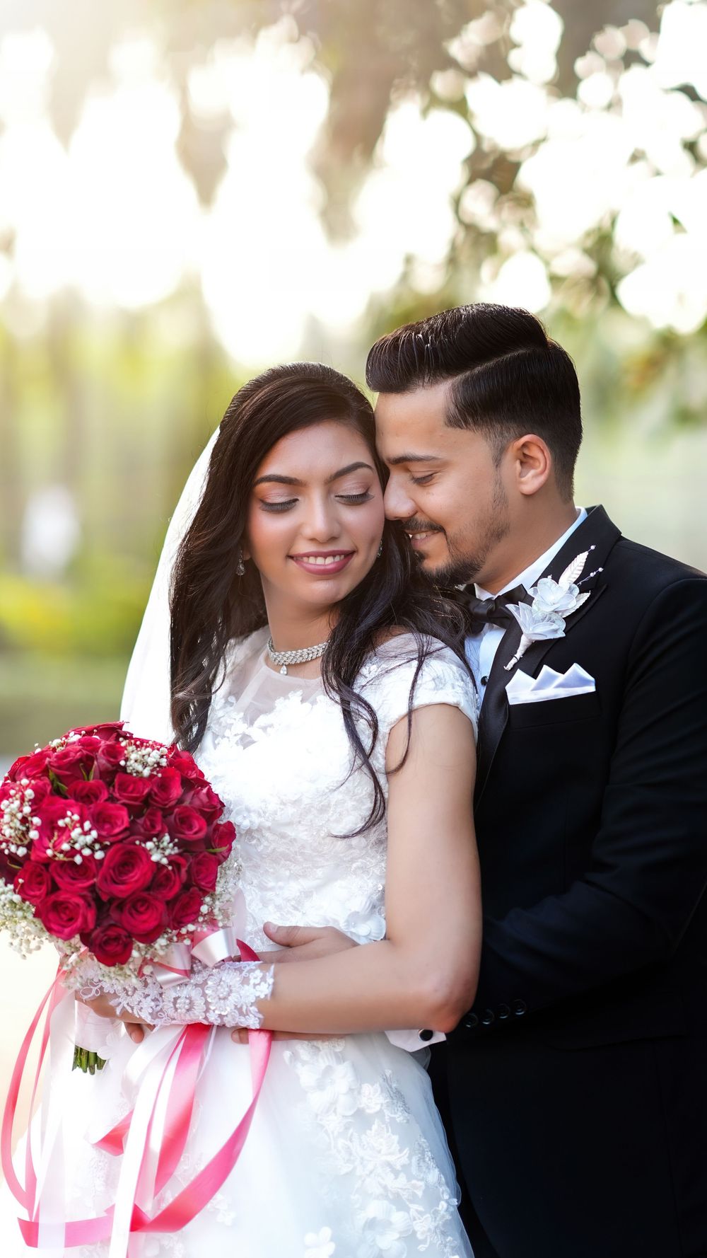Bride and groom posing together with a bouquet during their wedding