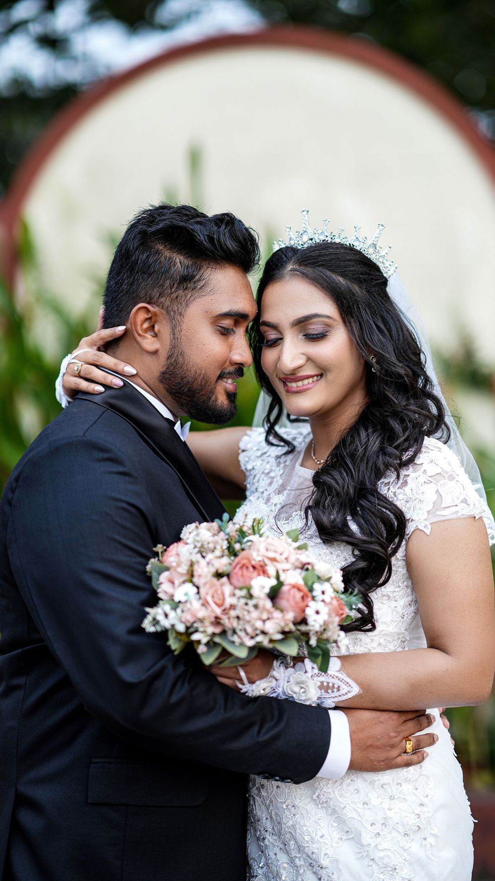 Bride and groom posing together with a wedding bouquet