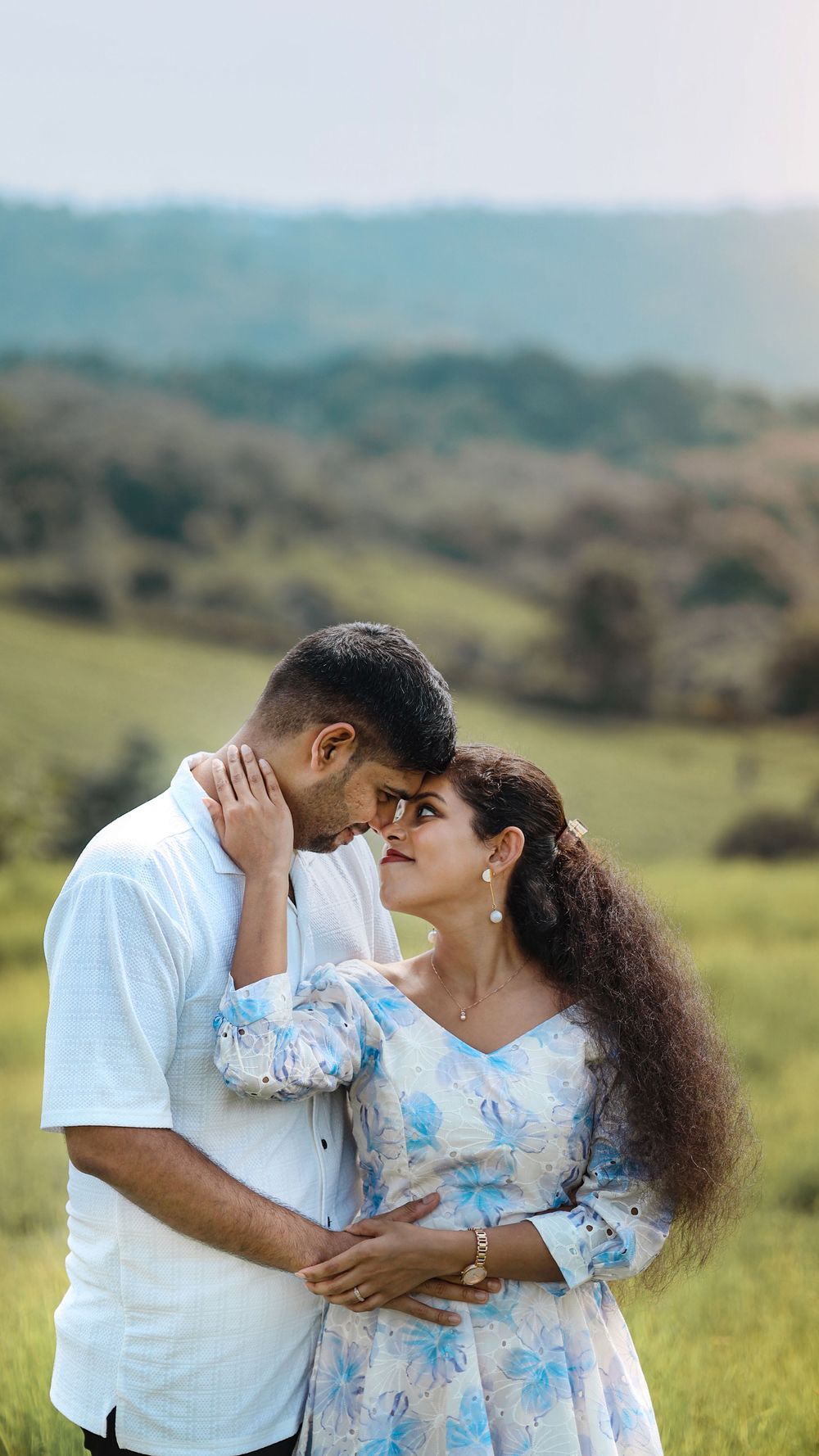 Couple posing together outdoors in a scenic landscape