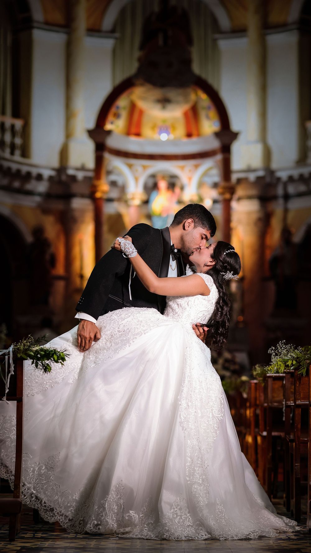 Bride and groom sharing a romantic moment inside a church