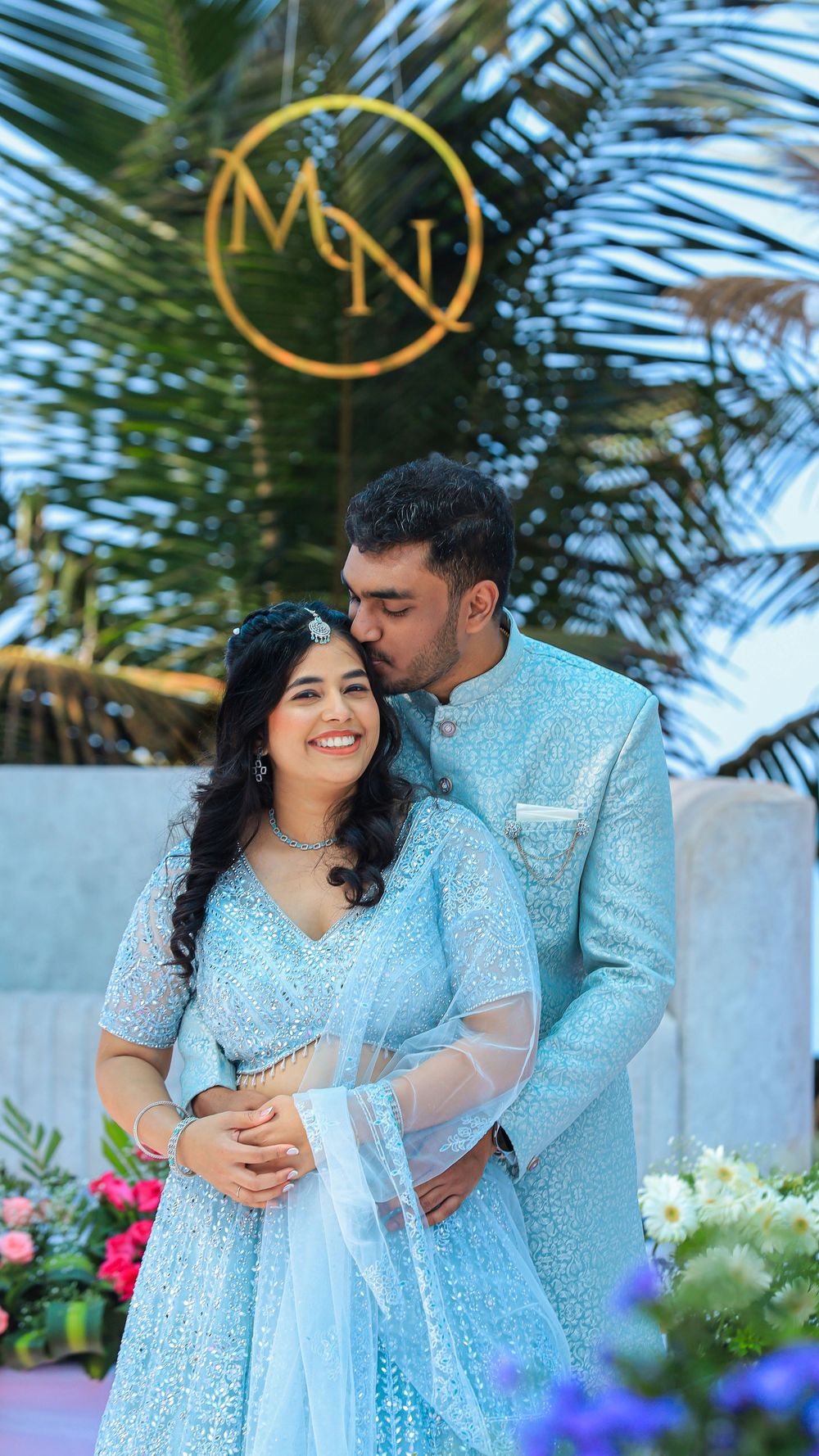Couple posing together outdoors in traditional blue outfits