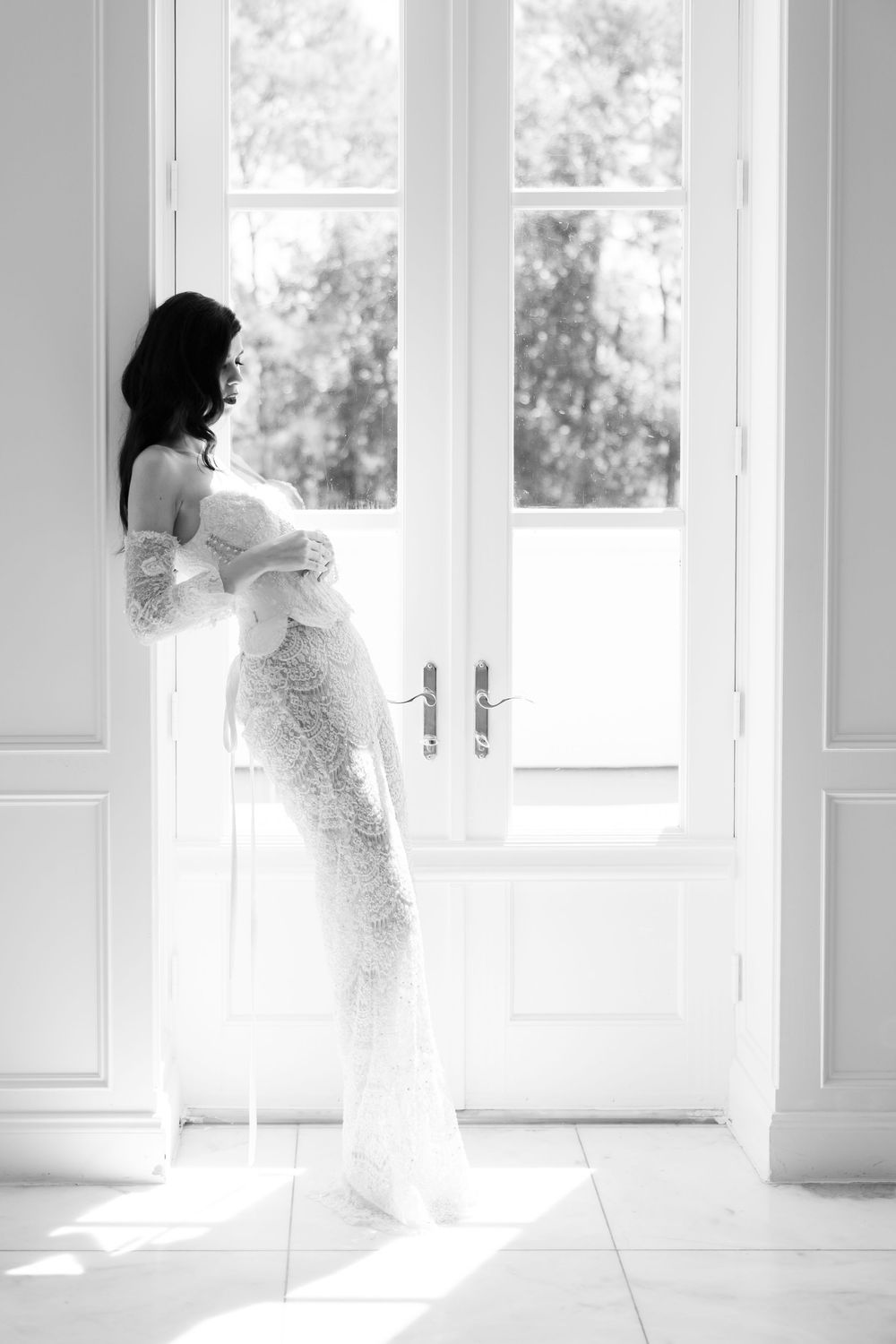 A series of four ethereal images show a figure in a white dress moving gracefully near bright sunlit windows.