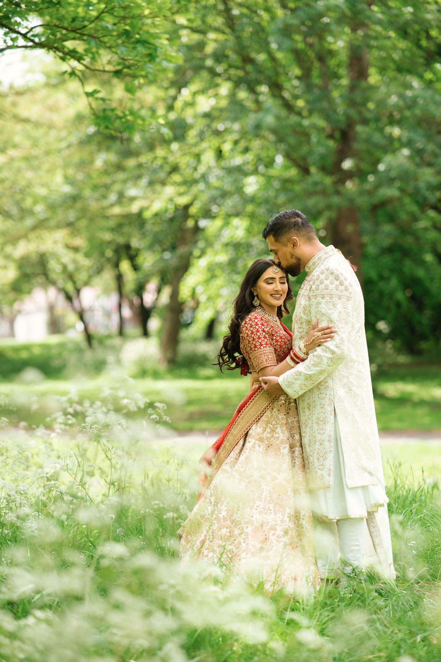 gorgeous newly weds dancing in the garden after marriage sharing their first kiss