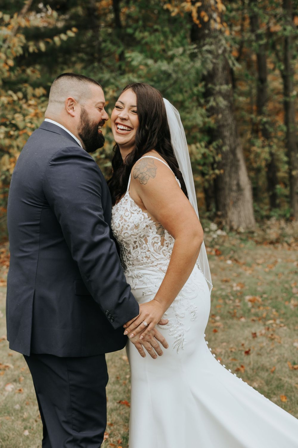 A romantic first look sequence captured between newlyweds in an autumn woodland setting.