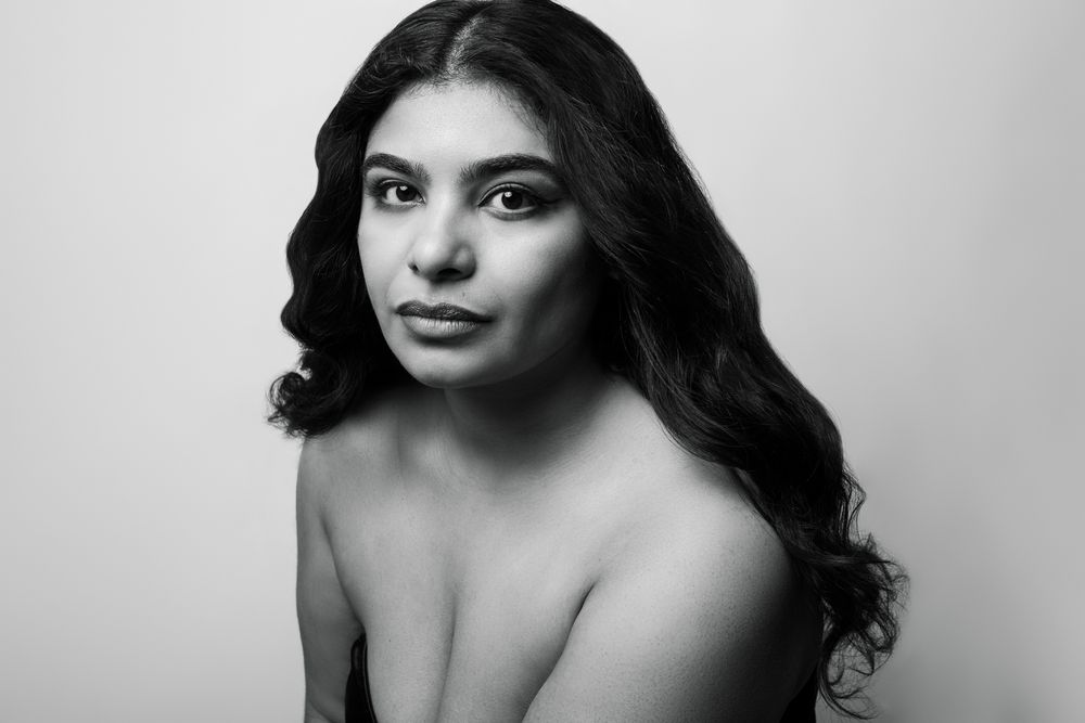 Black and white intimate portrait series showing artistic poses against neutral background.