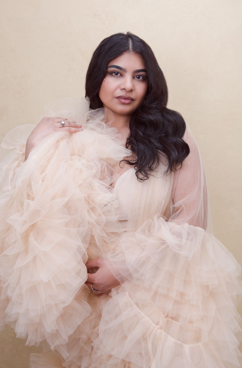 Romantic portraits featuring flowing peach tulle fabric against neutral backdrop.