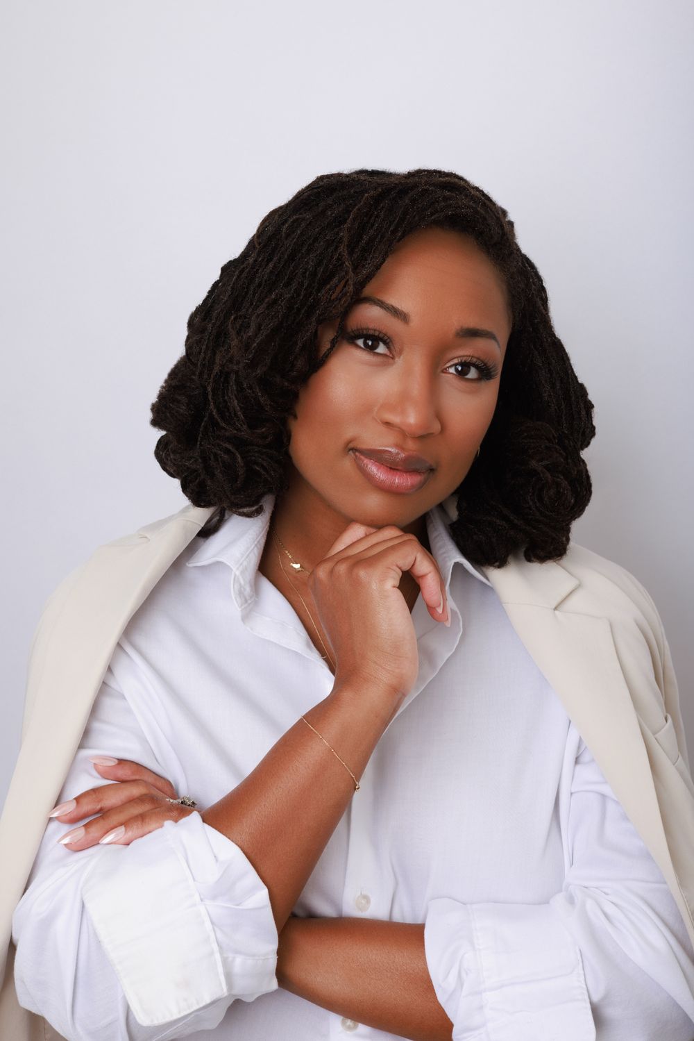 Portrait series showing a person in white shirt and cream blazer with braided hair against light background.