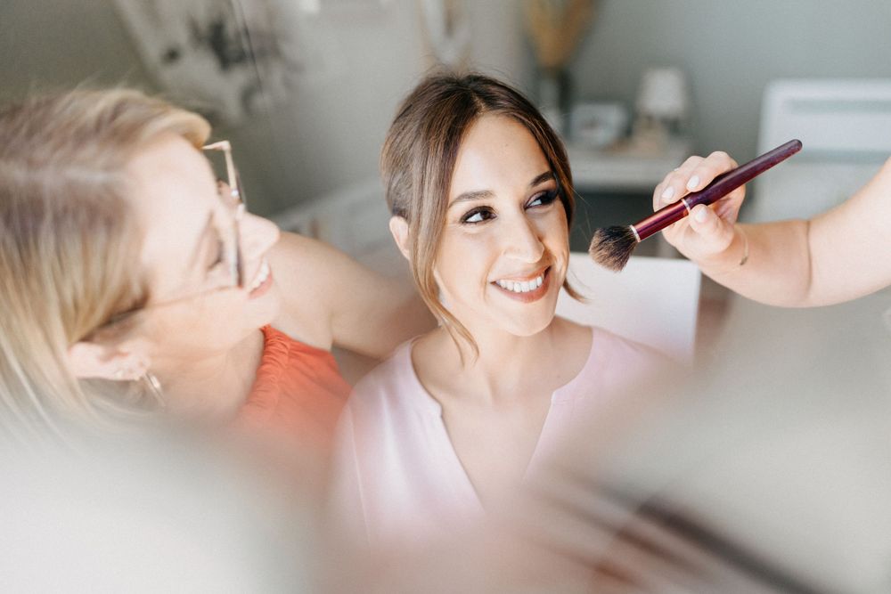 Getting ready scene with makeup being applied before wedding ceremony.
