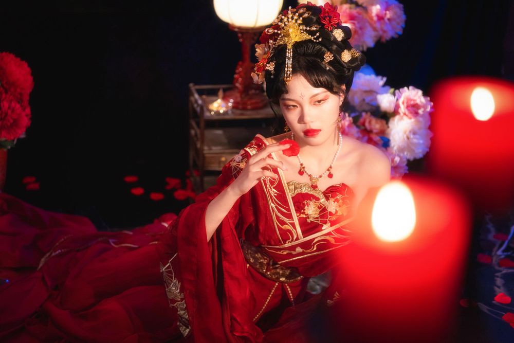 Alluring red spider lily Hanfu portrait with soft lighting, red candles, and a mirrored floor, by Imagine Image Studio.