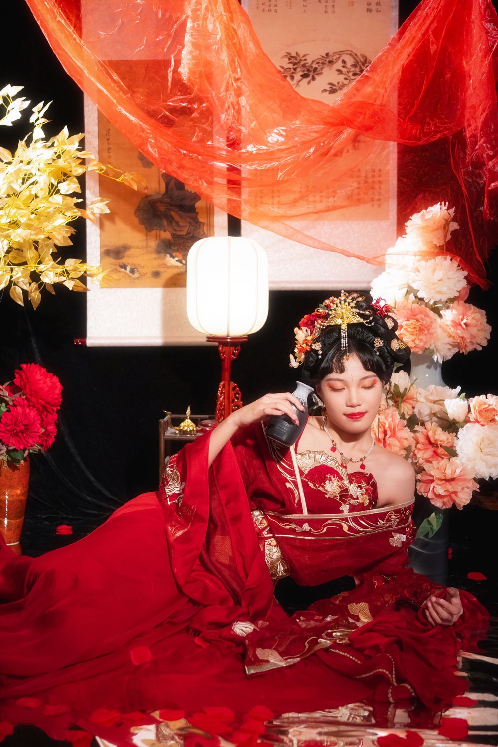Sensual and serene red-toned Hanfu studio portrait among spider lilies and glowing candles, by Imagine Image Studio.