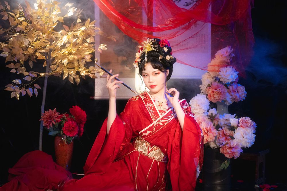 Softly lit, elegant Hanfu solo portrait on a mirrored floor surrounded by red spider lilies, by Imagine Image Studio.