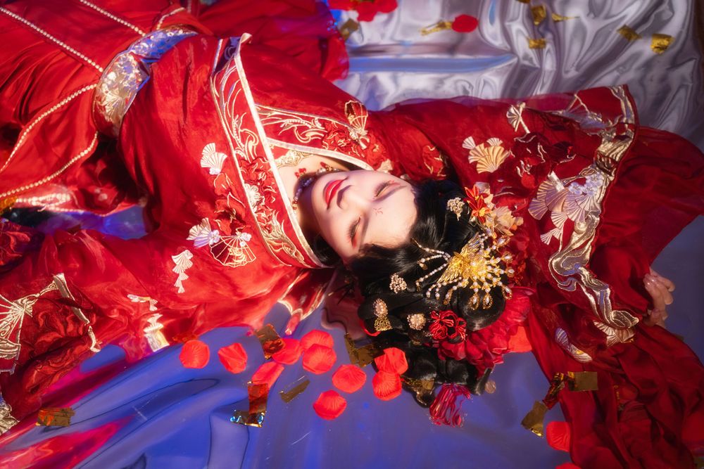 Alluring red spider lily Hanfu portrait with soft lighting, red candles, and a mirrored floor, by Imagine Image Studio.