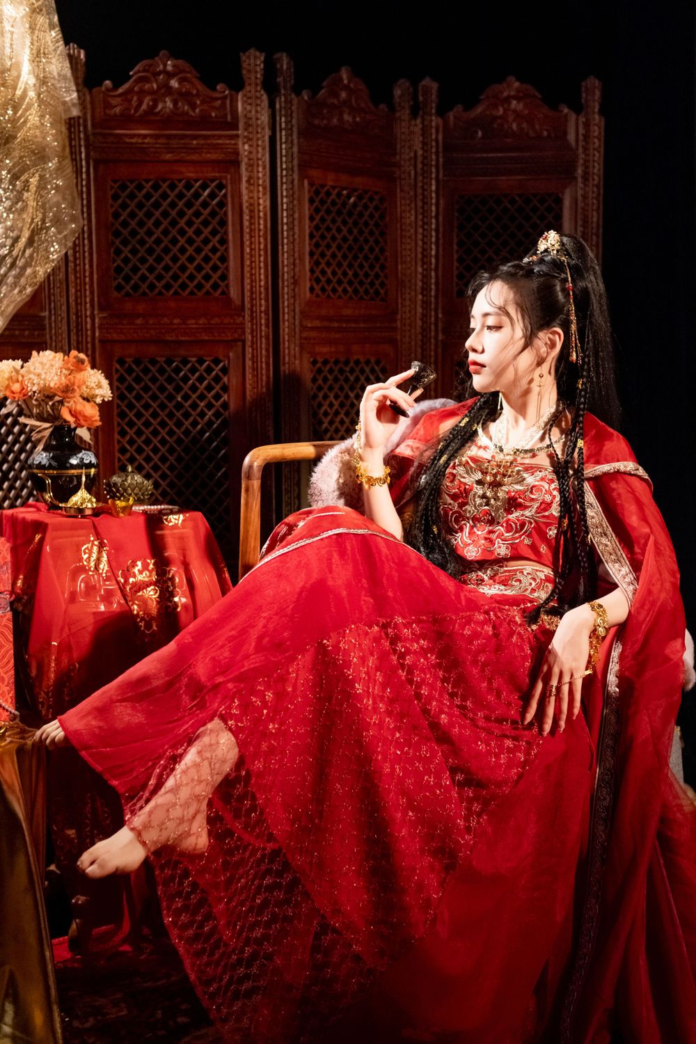Dynamic photo of a beautiful assassin in red Western Regions Hanfu dancing among gold, silver, and flowers. Studio shot by Imagine Image Stu