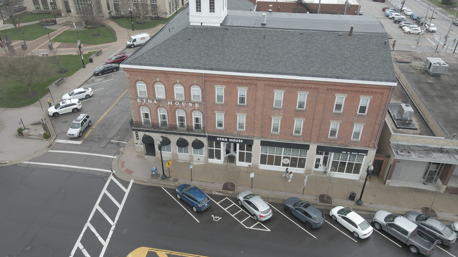 Aerial view of a commercial building with parking, showcasing real estate photography by Empax Studios.