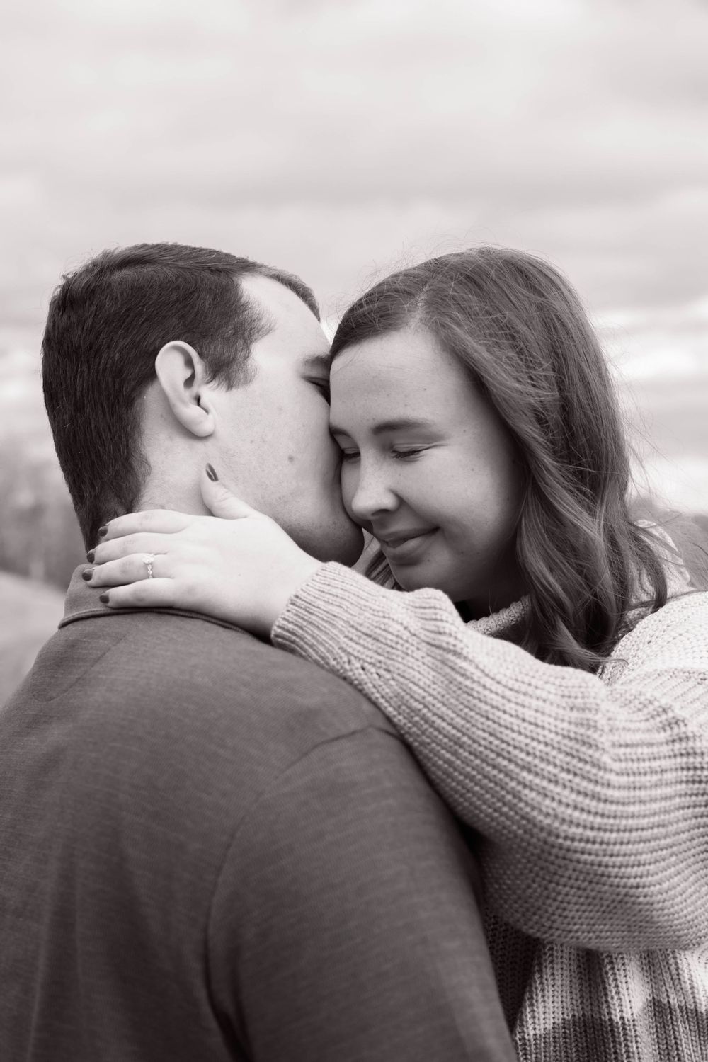 An intimate black and white series of a couple embracing in tender moments.