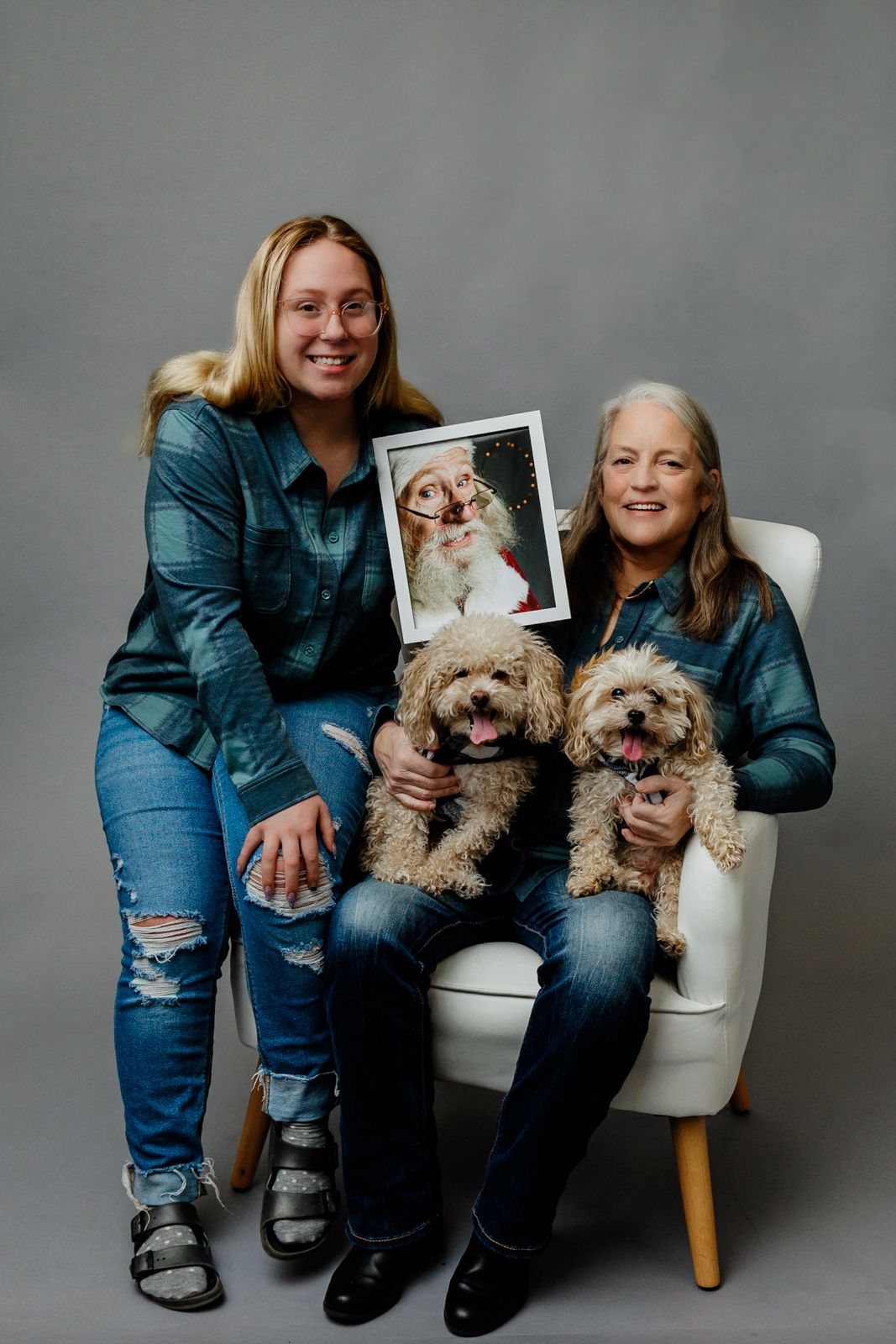 In studio Mother and daughter portrait with pups and picture of departed loved one