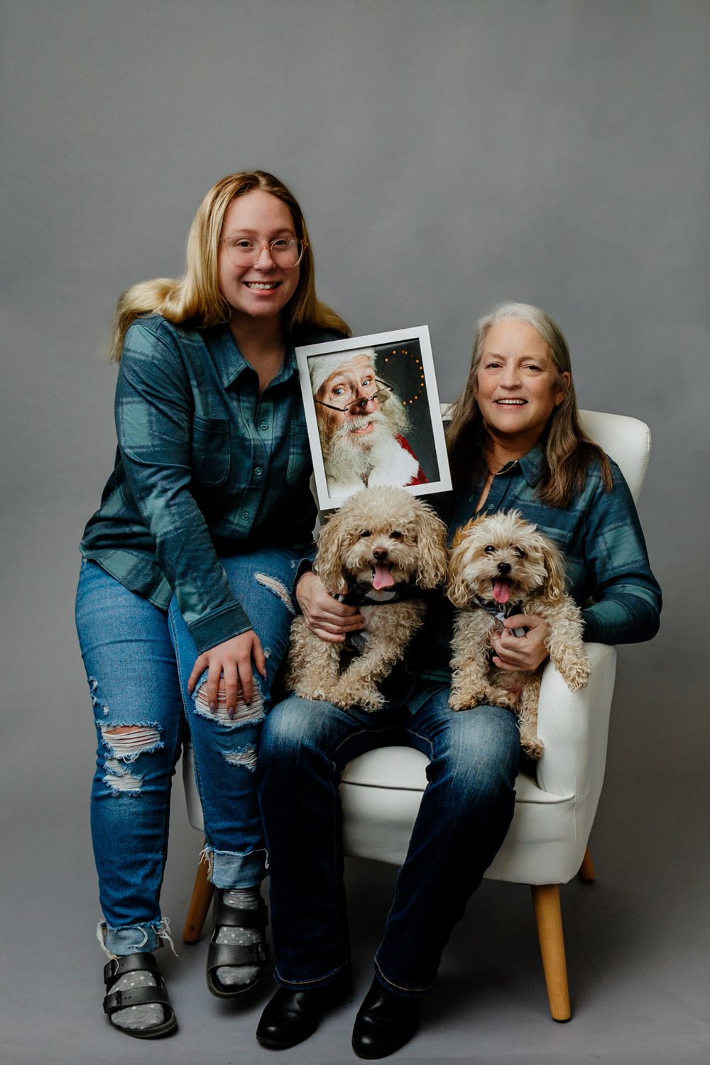 In studio Mother and daughter portrait with pups and picture of departed loved one
