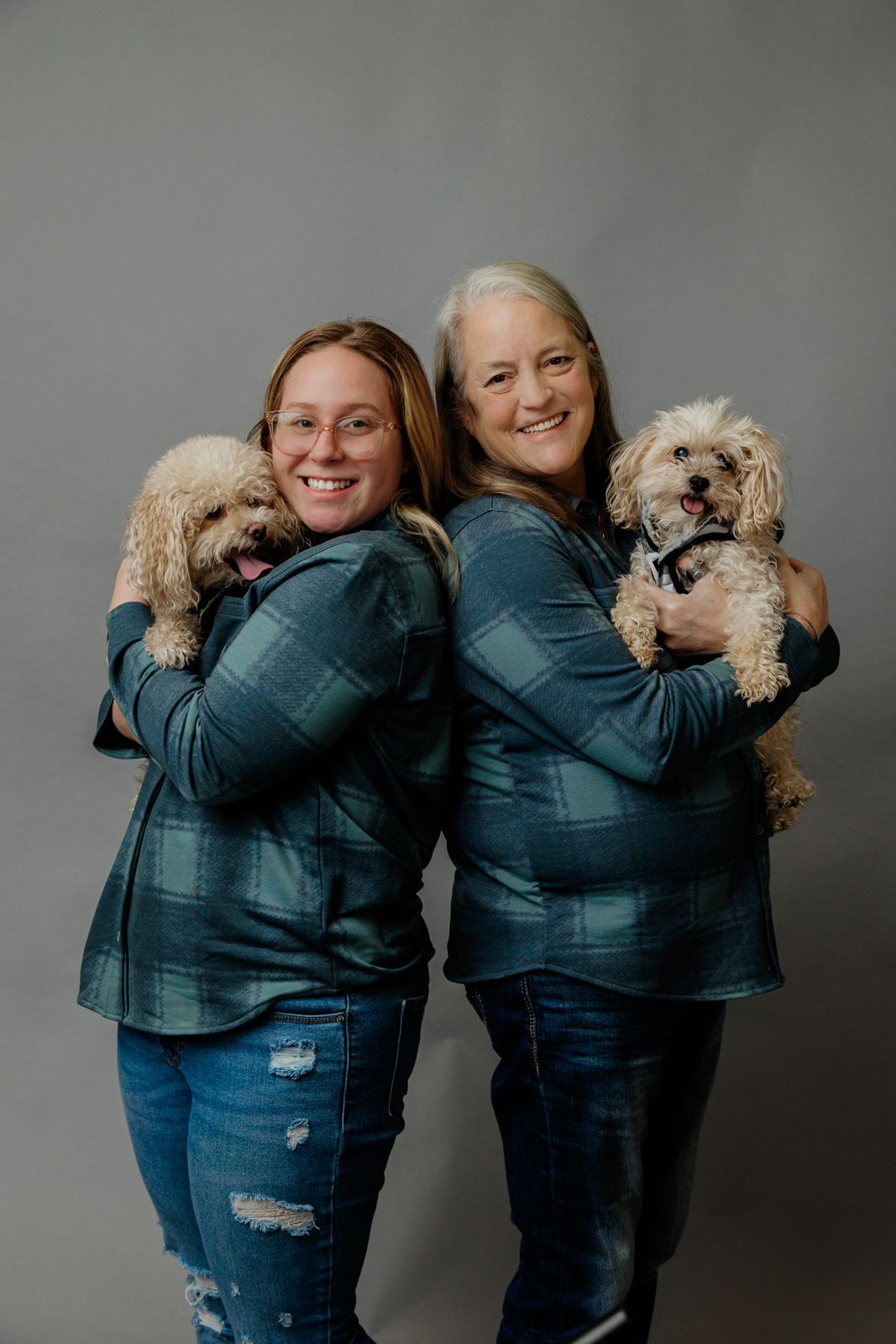 In studio Mother and daughter portrait with pups