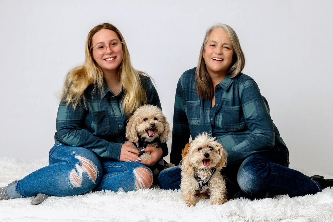 In studio Mother and daughter portrait with pups
